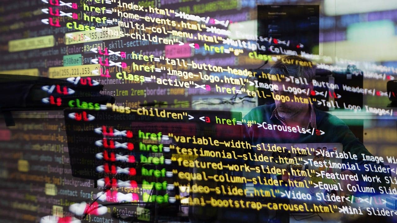 Laptop screen showing website code and design elements.